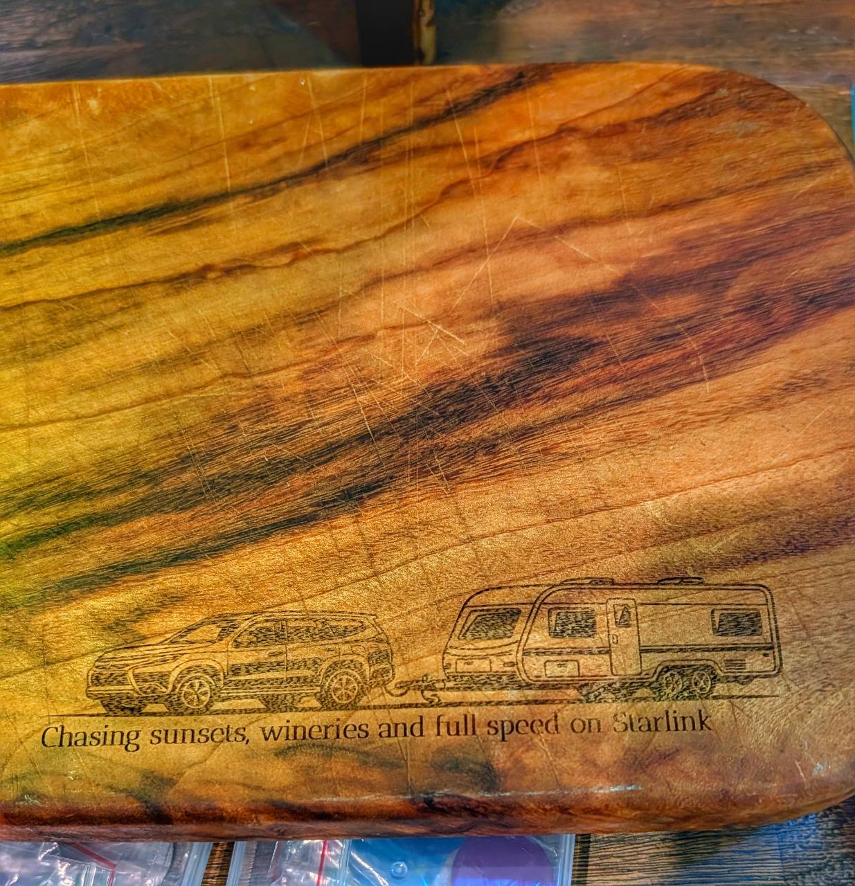 Wooden cheese board engraved with a custom caravan and four-wheel-drive graphic
